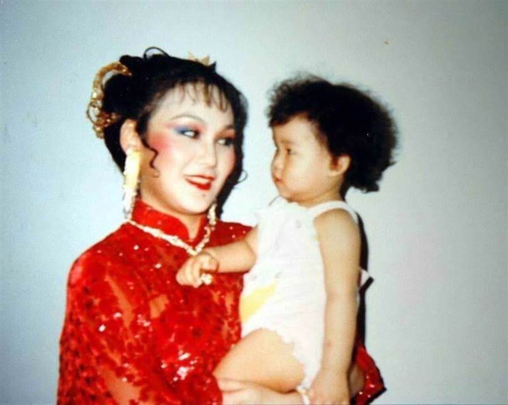 胡錦秀出年輕時抱著女兒的合照。（胡錦提供）