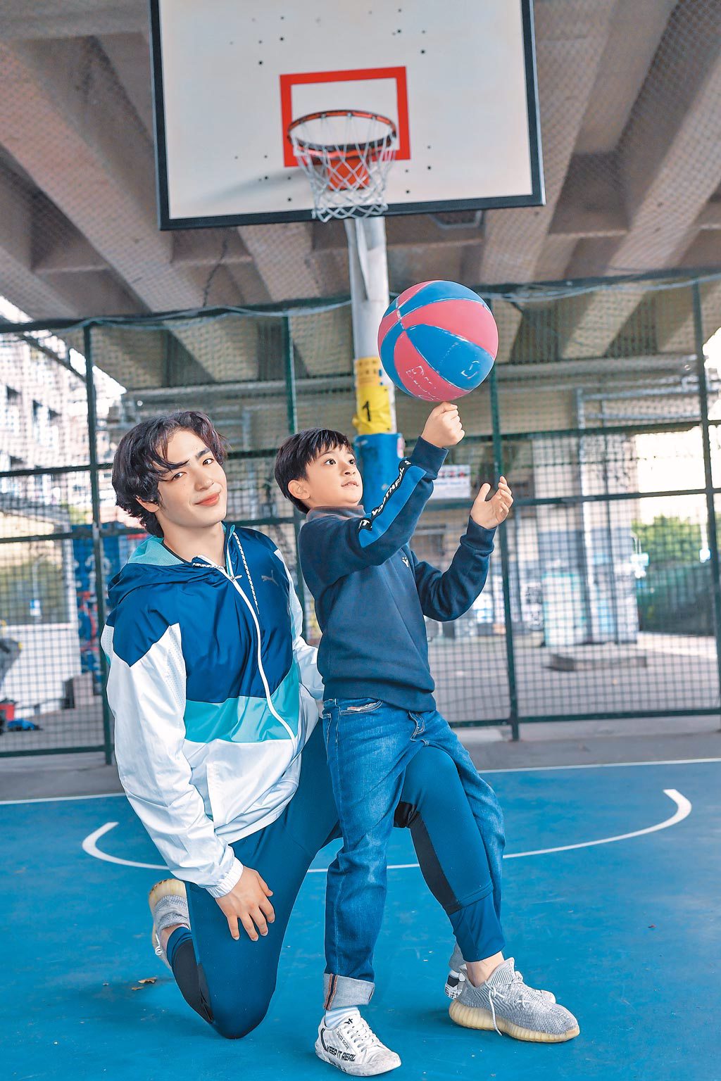 黃士杰（左）帶著想要長高的師弟葉小毅打籃球。（盧禕祺攝）