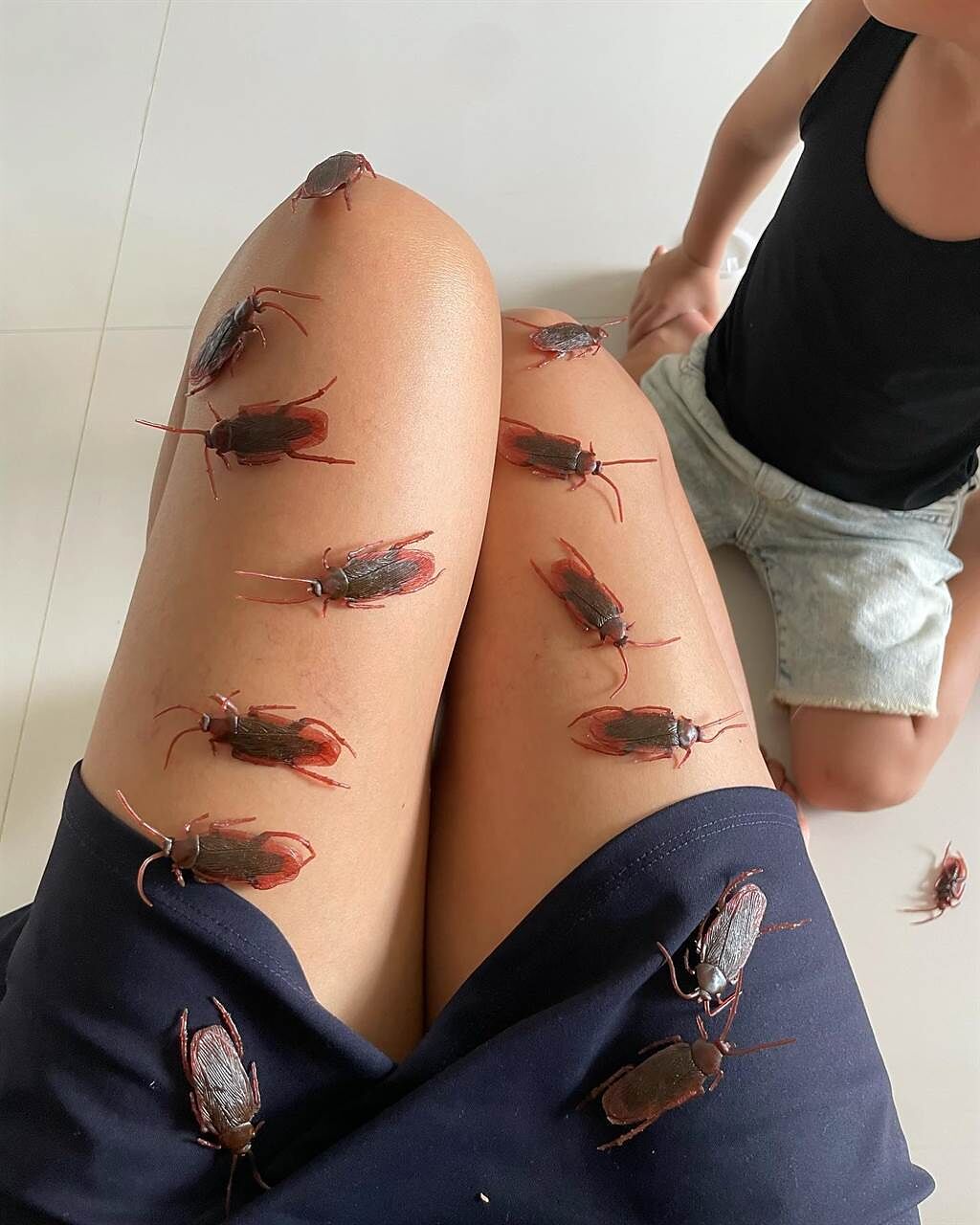 劉香慈曬育兒照，她的美腿排了許多假蟑螂。（圖／取材自劉香慈 Chantel Liu臉書）