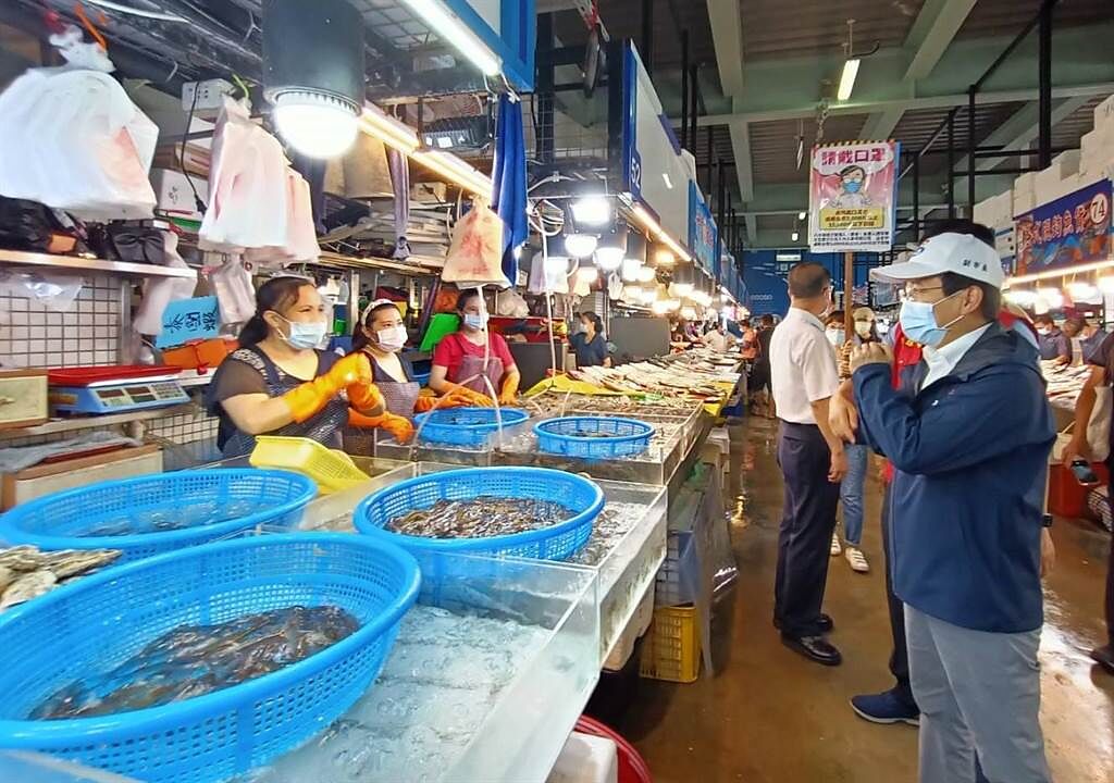 高雄市副市長林欽榮（右）向蚵子寮魚貨直銷中心魚販問好。（高雄市海洋局提供／林瑞益高雄傳真）