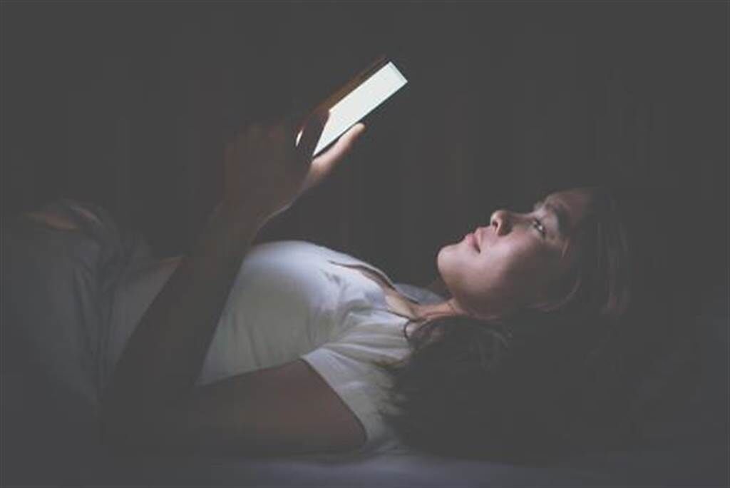 智慧型手機普及，也導致許多人習慣睡前滑上一段時間才願意入睡。(示意圖／shutterstock)